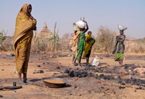 darfuri-women-walk-through-the-ruins-of-sirba-village-ransacked-during-a-government-offensive-near-west-darfurs-capital-el-geneina